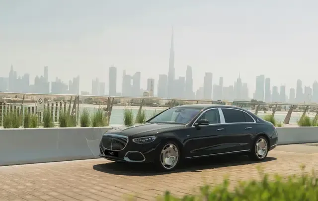 Luxury car with the Dubai skyline