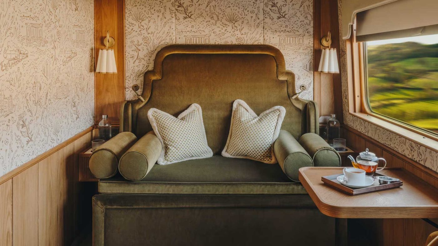 A cabin with a sofa at the window and the country passing by