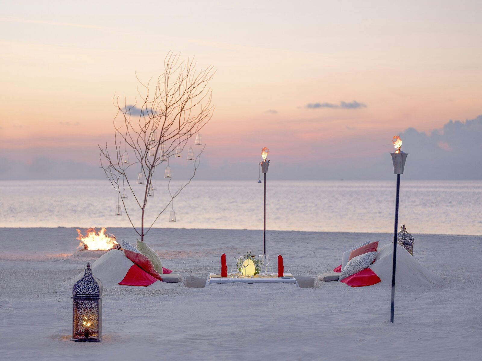 A couple on an empty shore at sunset