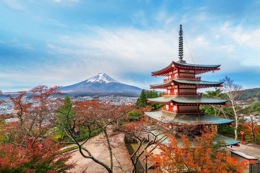 A five-storey pagoda among autumn maples with Mount Fuji behind