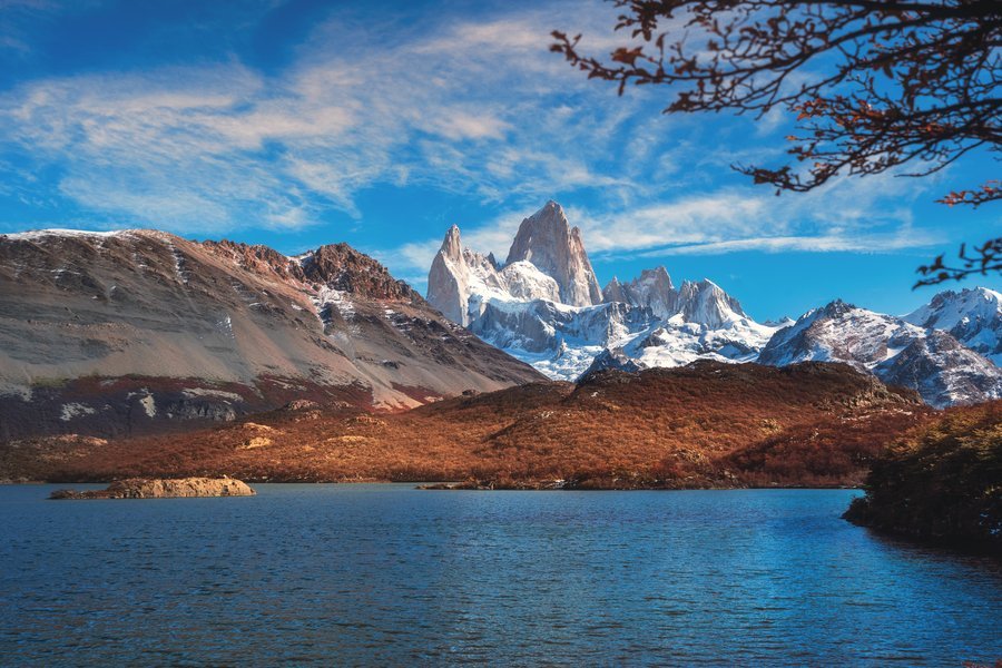 A turquoise river below jagged Andean peaks